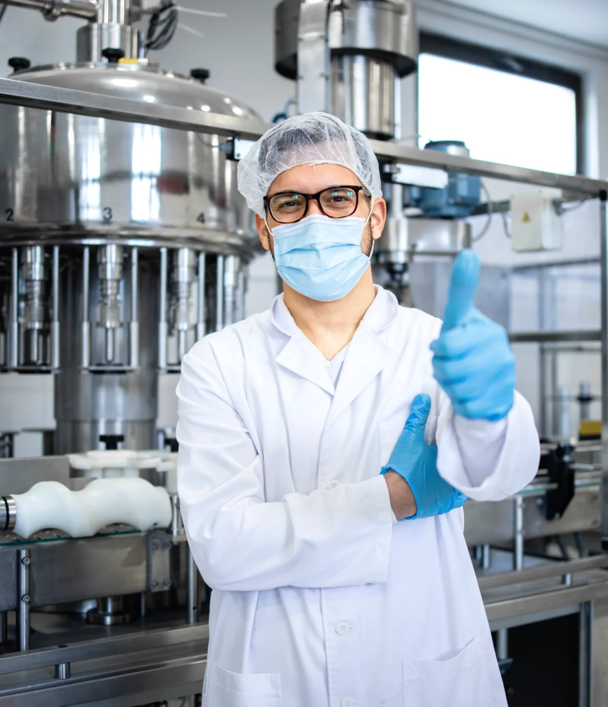 Operator at a pharmaceutical manufacturing facility giving a thumbs up, smiling