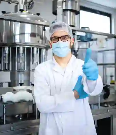 Operator at a pharmaceutical manufacturing facility giving a thumbs up, smiling